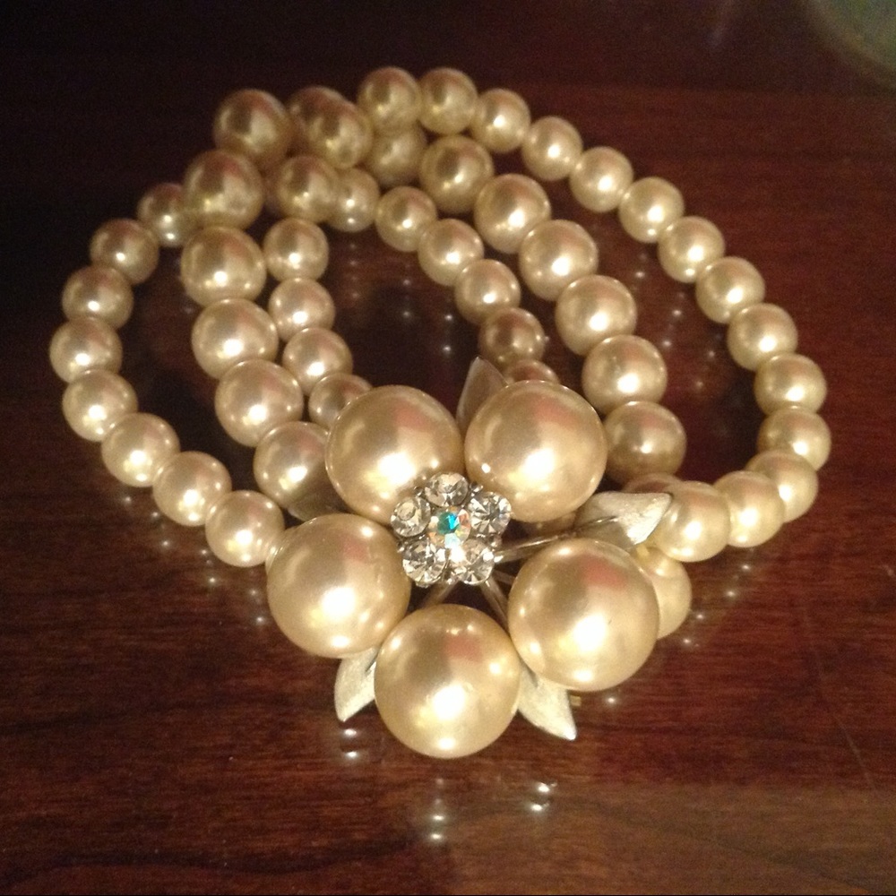 Faux pearl triple strand statement bracelet.